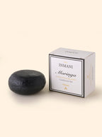 THE INMANI Moringa Balsam Bar. En naturlig, letvægts conditioner bar med aktivt kul og moringaolie til at pleje fedtet hovedbund og fint hår uden at tynge.